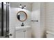 Stylish half-bathroom featuring shiplap walls, a round mirror, and modern fixtures at 90 Thomas Overby Dr, Sharpsburg, GA 30277