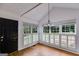 Bright dining area featuring wood floors, large windows, modern shutters, and a stylish chandelier at 90 Thomas Overby Dr, Sharpsburg, GA 30277