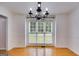Bright dining room with hardwood floors, large windows, and classic wainscoting at 90 Thomas Overby Dr, Sharpsburg, GA 30277