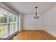Elegant dining room with hardwood floors, large windows, and a chandelier at 90 Thomas Overby Dr, Sharpsburg, GA 30277