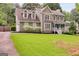 A spacious two-story home featuring a well-maintained lawn and an attached two-car garage at 90 Thomas Overby Dr, Sharpsburg, GA 30277