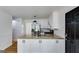 Updated kitchen featuring white cabinets, granite countertops, stainless steel appliances and modern fixtures at 90 Thomas Overby Dr, Sharpsburg, GA 30277