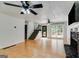 Spacious living room showcasing hardwood floors, a fireplace, and stairs to the upper level at 90 Thomas Overby Dr, Sharpsburg, GA 30277