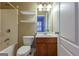 Bathroom with bathtub, shower, and floating shelves for storage at 275 Autry Mill Ln, Suwanee, GA 30024