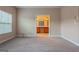 Neutral bedroom with carpet flooring, one window and a view of the kitchen at 275 Autry Mill Ln, Suwanee, GA 30024