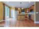 Spacious kitchen featuring an island, stainless steel appliances, and sliding glass door to outdoor deck at 275 Autry Mill Ln, Suwanee, GA 30024
