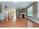 Spacious living room boasting gleaming hardwood floors, a cozy fireplace, staircase, and natural light at 275 Autry Mill Ln, Suwanee, GA 30024