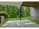 View of the back patio with swing set, green grass, and privacy landscaping at 733 Wexford Cove Way, Mableton, GA 30126