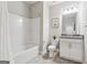 Bathroom featuring a shower and bathtub combo, single sink vanity, toilet, and framed mirror at 733 Wexford Cove Way, Mableton, GA 30126