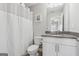 This bathroom features a shower with a white shower curtain and a vanity with grey countertops at 733 Wexford Cove Way, Mableton, GA 30126