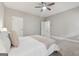 Bright bedroom features a ceiling fan, a comfortable queen-size bed, and two windows at 733 Wexford Cove Way, Mableton, GA 30126
