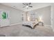 Bedroom features a ceiling fan, an exit door, a large window, and is decorated with decorative pictures at 733 Wexford Cove Way, Mableton, GA 30126