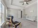 Bright bedroom boasts a large window with neighborhood views, recessed lights, a ceiling fan, and a white crib at 733 Wexford Cove Way, Mableton, GA 30126