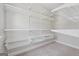 Walk-in closet with carpeted floor and wire shelving on all walls, maximizing storage space at 733 Wexford Cove Way, Mableton, GA 30126