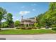 Beautiful community clubhouse surrounded by green lawns, mature trees, and vibrant landscaping at 733 Wexford Cove Way, Mableton, GA 30126