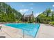 Community pool with several lounge chairs surrounding it and mature trees in the background at 733 Wexford Cove Way, Mableton, GA 30126