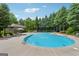 Community pool with lounge chairs surrounded by mature trees at 733 Wexford Cove Way, Mableton, GA 30126