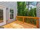 Outdoor deck with wood railings offers a view of surrounding trees and the yard at 733 Wexford Cove Way, Mableton, GA 30126