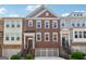 Charming townhome featuring a brick facade, attached garage, and welcoming entryways at 733 Wexford Cove Way, Mableton, GA 30126