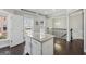 Well-lit kitchen island features a granite countertop with a view of the home's interior at 733 Wexford Cove Way, Mableton, GA 30126