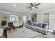 Spacious living room features a ceiling fan, with hardwood floors and a cozy seating area at 733 Wexford Cove Way, Mableton, GA 30126