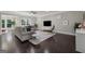 Inviting living room boasts dark hardwood floors, ample seating, and a mounted television at 733 Wexford Cove Way, Mableton, GA 30126