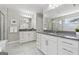 Dual vanities with granite countertops and tiled flooring enhance this spacious primary bathroom at 733 Wexford Cove Way, Mableton, GA 30126