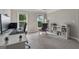 Home office space featuring a modern desk, chair, and natural light from the large windows at 733 Wexford Cove Way, Mableton, GA 30126