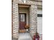 Charming front entrance with brick detail and welcoming door mat, creating an inviting entryway at 7177 Fringe Flower Dr, Austell, GA 30168