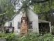 Back exterior featuring porch, chimney, and general disrepair on the property at 11591 Turner Rd, Hampton, GA 30228