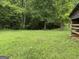 Exterior view with partial barn visible in grassy backyard setting at 11591 Turner Rd, Hampton, GA 30228