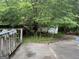 Backyard concrete patio with foliage and greenery surrounding a detached structure at 11591 Turner Rd, Hampton, GA 30228