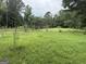 Picturesque grassy backyard with a charming wooden fence at 11591 Turner Rd, Hampton, GA 30228