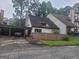 Charming townhome with a carport and quaint front yard, surrounded by mature trees in a quiet setting at 7 Willowick Dr, Lithonia, GA 30038
