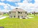 Expansive backyard featuring lush green grass and a patio set perfect for outdoor entertaining at 117 Elkins Blvd, Locust Grove, GA 30248