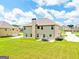 Spacious backyard with lush green grass and a patio set for outdoor dining or relaxation at 117 Elkins Blvd, Locust Grove, GA 30248