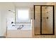 Modern bathroom with separate shower, tub, and decorative tile at 117 Elkins Blvd, Locust Grove, GA 30248