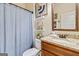 Cozy bathroom with granite countertop, wood vanity, and blue shower curtain at 117 Elkins Blvd, Locust Grove, GA 30248