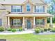 Beautiful brick home with well-manicured landscaping and a welcoming front porch at 117 Elkins Blvd, Locust Grove, GA 30248