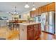 Open-concept kitchen featuring a center island, stainless steel appliances, and seamless flow to the dining area at 117 Elkins Blvd, Locust Grove, GA 30248