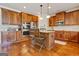 Spacious kitchen featuring stainless steel appliances, wood cabinets, and a functional center island at 117 Elkins Blvd, Locust Grove, GA 30248