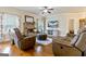Cozy living room featuring a stone fireplace, comfortable seating, and a large screen television at 117 Elkins Blvd, Locust Grove, GA 30248
