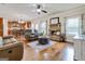 Open-concept living room featuring a stone fireplace, wood floors, and comfortable leather seating at 117 Elkins Blvd, Locust Grove, GA 30248
