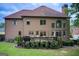 Back exterior view featuring a deck, large windows, and a well-manicured lawn at 1952 Sugarstone Dr, Lawrenceville, GA 30043