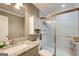Bathroom with granite countertop vanity, a toilet, and a glass-enclosed shower with neutral wall colors at 1952 Sugarstone Dr, Lawrenceville, GA 30043