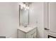 Bathroom featuring a white vanity with a white countertop, a modern mirror and bright lighting at 1952 Sugarstone Dr, Lawrenceville, GA 30043