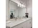 Luxurious bathroom featuring double vanity with marble countertops and large mirror at 1952 Sugarstone Dr, Lawrenceville, GA 30043