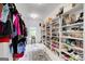 Well-organized walk-in closet offers ample storage with shelving for shoes, accessories, and hanging clothes at 1952 Sugarstone Dr, Lawrenceville, GA 30043