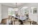 Refined dining room with a large table, modern chandelier, and open layout at 1952 Sugarstone Dr, Lawrenceville, GA 30043
