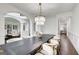 Spacious dining room featuring a large table, stylish chairs, and elegant lighting at 1952 Sugarstone Dr, Lawrenceville, GA 30043